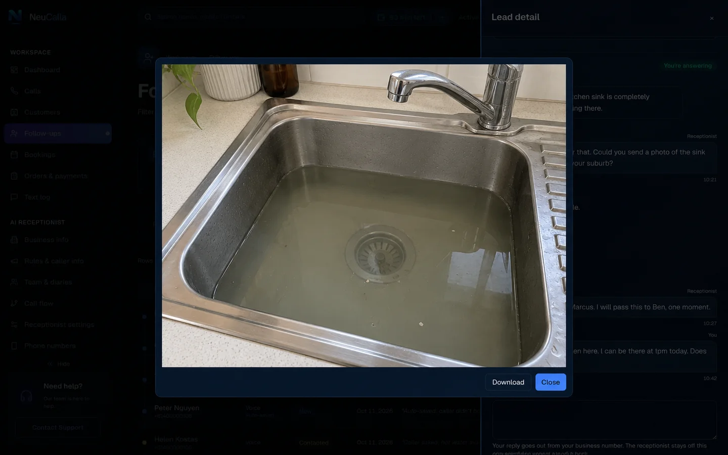 Example customer photo of a blocked kitchen sink half-filled with standing water, opened from the conversation with Download and Close